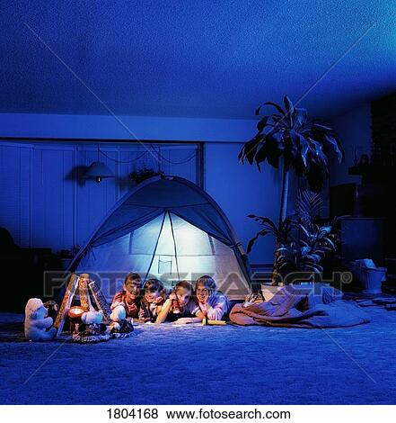 Girls sitting in a tent in the living room View Large Photo Image Stock Photo - Girls sitting in a tent in the living room. Fotosearch