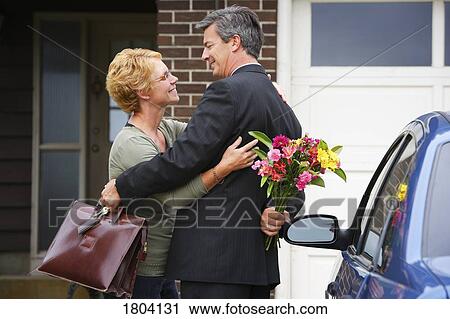 Stock Image - Greeting between husband and wife. Fotosearch