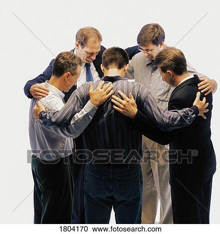 Group of men standing in a circle and praying View Large Photo Image Stock Image - Group of men standing in a circle and praying. Fotosearch