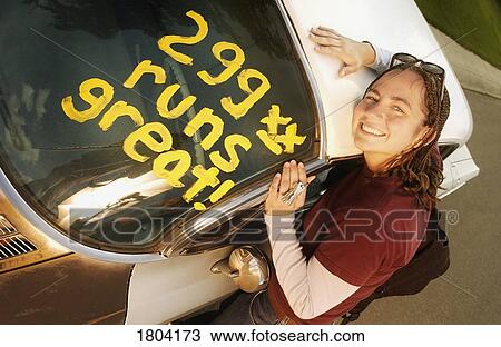High angle view of a girl leaning over car View Large Photo Image Stock Image - High angle view of a girl leaning over car. Fotosearch