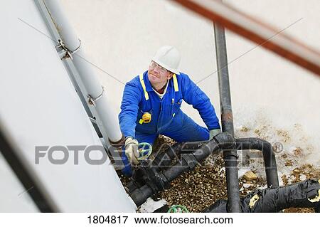 High angle view of an industrial worker View Large Photo Image Stock Photo - High angle view of an industrial worker. Fotosearch
