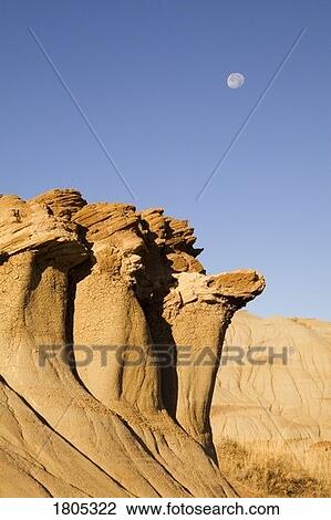 Hoodoos and moon with blue sky in Alberta, Canada View Large Photo Image Stock Image - Hoodoos and moon with blue sky in Alberta, Canada . Fotosearch