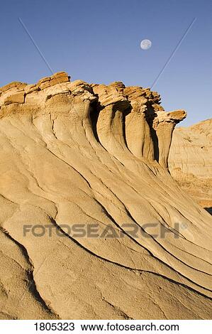 Hoodoos and moon with blue sky in Alberta, Canada View Large Photo Image Stock Image - Hoodoos and moon with blue sky in Alberta, Canada . Fotosearch