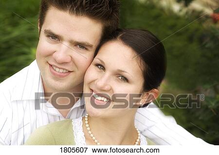 Stock Photo - Image of couple smiling and having their photo taken. Fotosearch