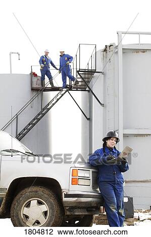 Industrial workers at an oilfield View Large Photo Image Stock Image - Industrial workers at an oilfield. Fotosearch