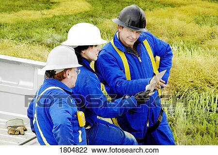 Industrial workers talking View Large Photo Image Stock Image - Industrial workers talking. Fotosearch