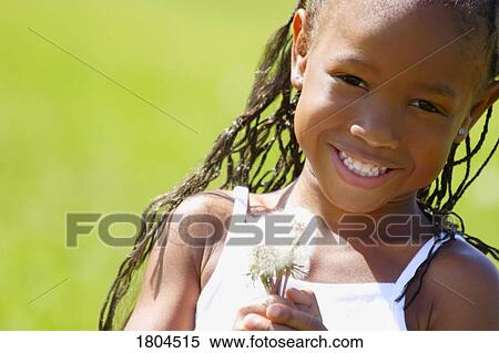 Stock Photography - Little girl holding weeds. Fotosearch