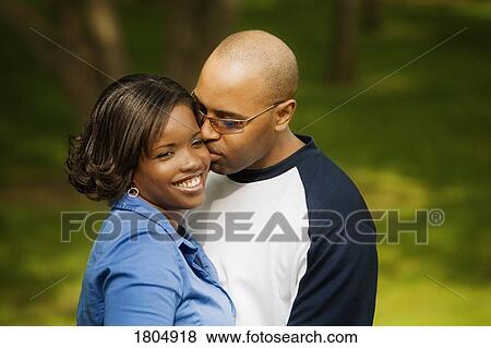 Stock Photo - Man kissing on the cheek. Fotosearch