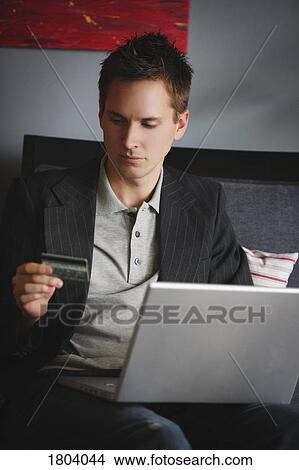 Man ordering something off the internet View Large Photo Image Picture - Man ordering something off the internet. Fotosearch
