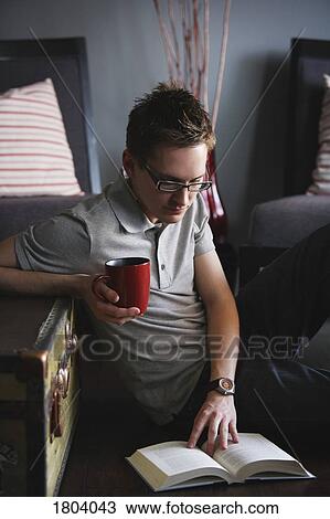 Man reading with hot drink View Large Photo Image Stock Image - Man reading with hot drink. Fotosearch