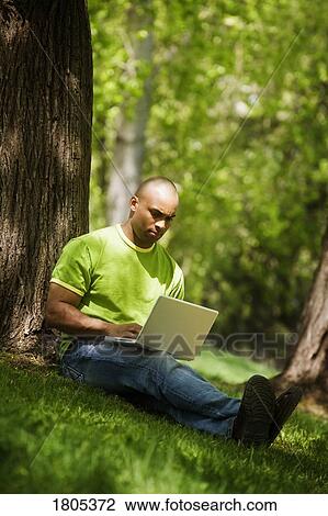 Man working on laptop computer View Large Photo Image Stock Image - Man working on laptop computer. Fotosearch