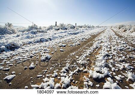 Melting snow on dirt road View Large Photo Image Stock Photo - Melting snow on dirt road. Fotosearch