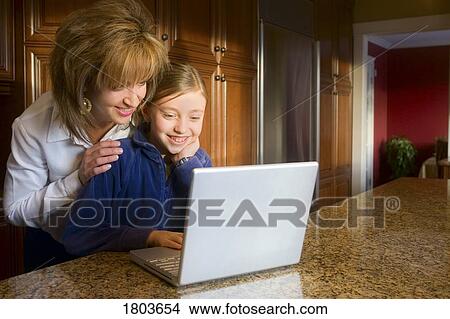 Mother and daughter using computer View Large Photo Image Picture - Mother and daughter using computer. Fotosearch