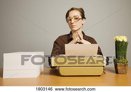 Office worker sitting at desk View Large Photo Image Stock Photograph - Office worker sitting at desk. Fotosearch