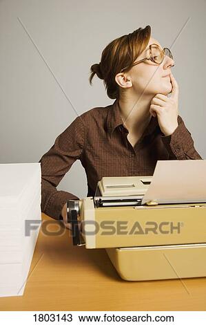 Office worker sitting at desk, thinking View Large Photo Image Stock Image - Office worker sitting at desk, thinking. Fotosearch