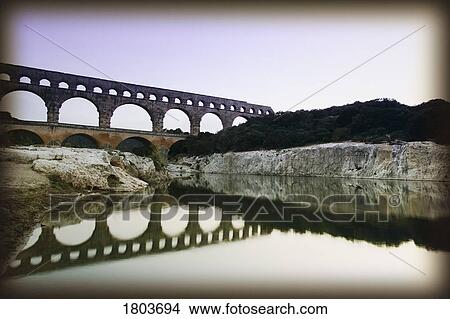 Picture - Old ruins of an aqueduct at Pont du Gard, Nimes, France . Fotosearch