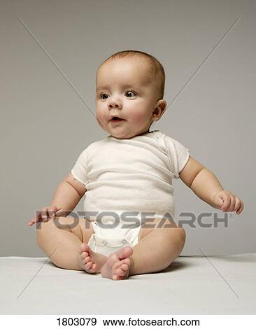 Stock Photo - One cute baby learning to sit upright. Fotosearch