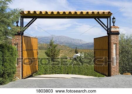 Stock Image - Open entrance gate with mountain view in Andalucia, Spain . Fotosearch