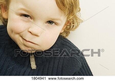 Stock Image - Portrait of a boy making face. Fotosearch