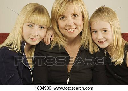 Stock Photograph - Portrait of a mother with two daughters. Fotosearch