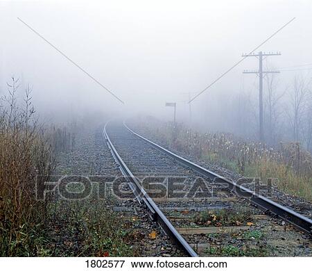 Stock Photo - Railroad tracks in the fog. Fotosearch