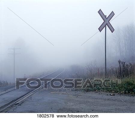 Railway crossing in the fog View Large Photo Image Stock Photo - Railway crossing in the fog. Fotosearch