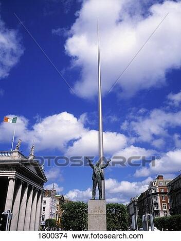 Picture - Sculpture of Jim Larkin and the Spire of Dublin in O'Connell Street, Dublin, Ireland. Fotosearch
