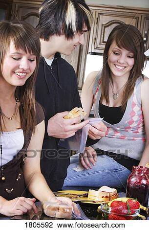 Siblings making lunch together View Large Photo Image Stock Image - Siblings making lunch together. Fotosearch