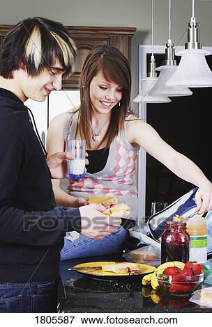Siblings making lunch together View Large Photo Image Stock Photo - Siblings making lunch together. Fotosearch