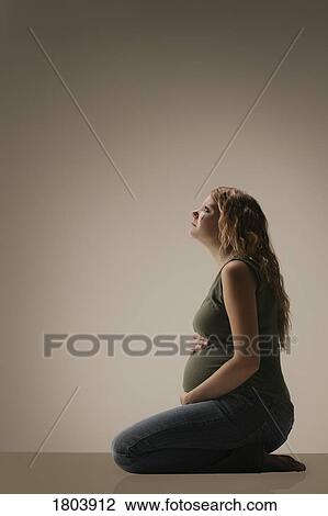Side view of a pensive pregnant woman View Large Photo Image Stock Image - Side view of a pensive pregnant woman. Fotosearch