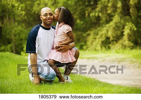 Side view of daughter kissing father View Large Photo Image Stock Photo - Side view of daughter kissing father. Fotosearch