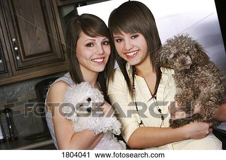 Sisters with puppies View Large Photo Image Stock Image - Sisters with puppies. Fotosearch