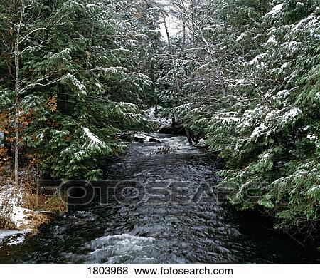 Stock Photo - Stream in winter, eastern townships, Quebec, Canada. Fotosearch