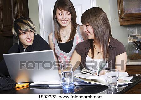 Stock Image - Students studying at home. Fotosearch