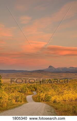 Sunset on gravel road in foothills during autumn View Large Photo Image Stock Image - Sunset on gravel road in foothills during autumn . Fotosearch