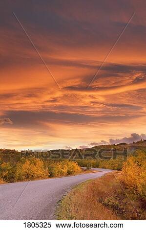 Stock Photography - Sunset over road in autumn, Alberta, Canada. Fotosearch
