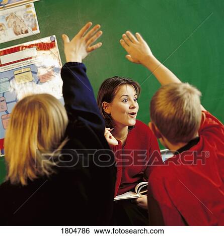 Teacher educating kids in a classroom View Large Photo Image Stock Photograph - Teacher educating kids in a classroom . Fotosearch