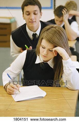 Teenage boy cheating off of classmate View Large Photo Image Stock Image - Teenage boy cheating off of classmate. Fotosearch