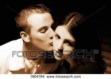 Teenage boy kissing teenage girl View Large Photo Image Picture - Teenage boy kissing teenage girl. Fotosearch