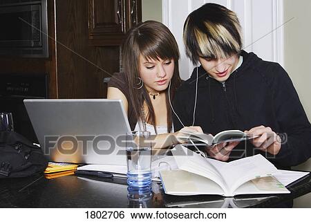 Stock Photograph - Teenage couple doing work. Fotosearch