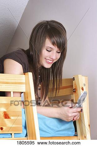Teenage girl texting on cell phone View Large Photo Image Stock Photography - Teenage girl texting on cell phone. Fotosearch
