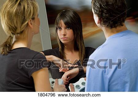 Teenager angry with friends for being late from playing video games View Large Photo Image Stock Photograph - Teenager angry with friends for being late from playing video games. Fotosearch