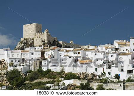Stock Image - Twelfth Century Moorish castle among village in Cádiz province, Andalucia, Spain . Fotosearch