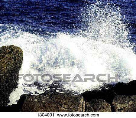 Waves crashing on rocky beach View Large Photo Image Stock Image - Waves crashing on rocky beach. Fotosearch