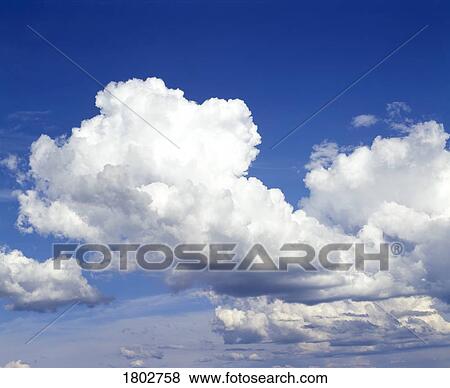 Stock Photo - White clouds on blue sky. Fotosearch