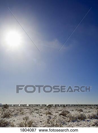 Winter scene with a train in the distance View Large Photo Image Stock Photo - Winter scene with a train in the distance. Fotosearch