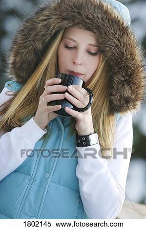 Woman drinking hot drink outside View Large Photo Image Stock Photography - Woman drinking hot drink outside. Fotosearch