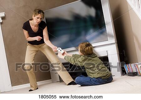 Woman frustrated with boy for playing video game View Large Photo Image Stock Photography - Woman frustrated with boy for playing video game. Fotosearch