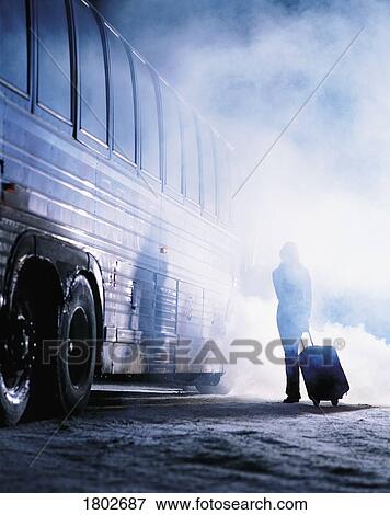Stock Photo - Woman getting on bus in winter. Fotosearch