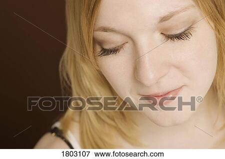 Stock Photo - Woman looking down. Fotosearch
